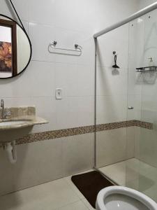 a bathroom with a shower and a toilet and a sink at Espaço Physis in Vila Velha