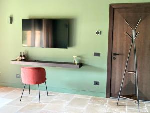 a room with a red chair and a shelf on the wall at Elegant suite with porch and shared pool in Adro