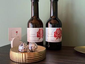 two bottles of wine and two donuts on a table at Elegant suite with porch and shared pool in Adro