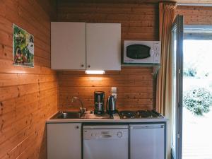 a small kitchen with a sink and a microwave at Cozy Cottage Retreat for Two in Moutiers-sous-Chantemerle