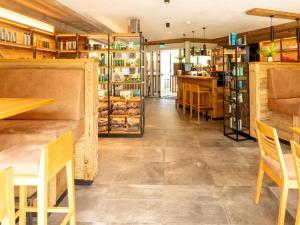 a restaurant with a counter and tables and chairs at Spacious suite for 8 guests with a private sauna in Rauris
