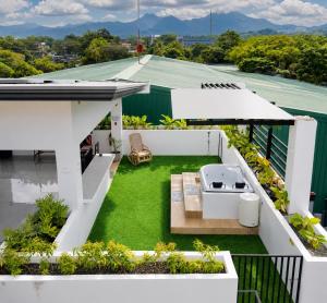 a view from the roof of a house with a garden at The Penthouse With Outdoor Jacuzzi Private Rooftop Solar Powered Energy in Puerto Princesa City