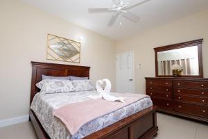 a bedroom with a bed with a swan on it at Oceanpointe Luxury Retreat-3 Bedroom Home in Point +34 photos