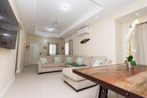 a living room with a couch and a table at Oceanpointe Luxury Retreat-3 Bedroom Home in Point