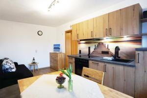 a kitchen with a table and a counter top at Paulhuberhof in Chieming +7 photos