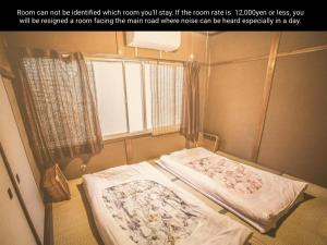 a hospital room with two beds and a window at Nostalgic guesthouse for 1 to 2 Females shared toilet and shower in Kyoto