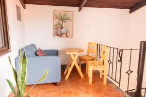 a living room with a blue couch and a table at Los Faroles Hotel & Spa in Antigua Guatemala