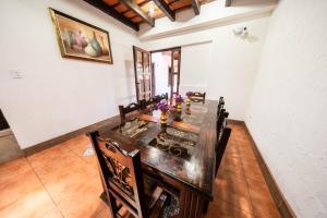 a dining room with a long table and chairs at Los Faroles Hotel & Spa in Antigua Guatemala +22 photos