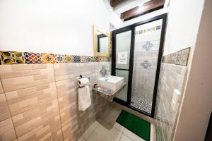 a bathroom with a sink and a mirror at Los Faroles Hotel & Spa in Antigua Guatemala
