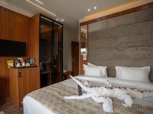 a bedroom with a large bed with a large white bedspread at Tuya pyramids INN in Cairo
