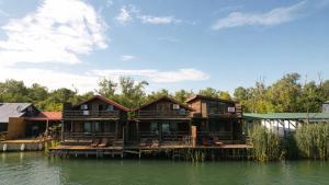 a house on a dock on the water at Sara Riverside Cottage in Ulcinj