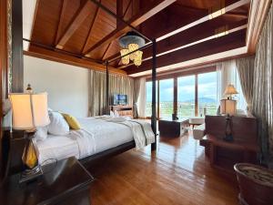 a bedroom with a large bed and a large window at Royal Legacy Golf Private Villa in Rawai Beach +285 photos
