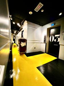 a hallway with a yellow floor in a subway car at JonkeRED Heritage Hotel in Malacca