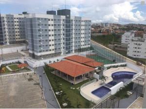 a building with a swimming pool and a large building at Apto aconchegante próximo à UFS in São Cristóvão