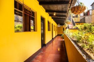 an empty hallway of a building with yellow walls at Hotel Itzel in Cobán