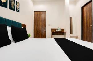 a bedroom with a large white bed and a desk at Hotel Agam-Railway Station Kota in Tīrath +17 photos