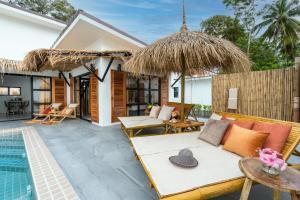 a villa with a swimming pool and a patio at Manao Pool Villa 6 - 5 Mins Walk To The Beach in Ko Lanta
