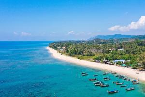 an aerial view of a beach with boats in the water at Manao Pool Villa 6 - 5 Mins Walk To The Beach in Ko Lanta