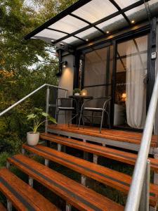 an outdoor deck with a pergola and a table at Cosy Studio- Blue Mountains in Wentworth Falls