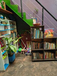 a room with a book shelf filled with books at Habitación cama doble con vista al bosque - 4 cuadras parque de Usaquen in Bogotá