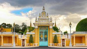 a yellow and blue building with a blue door at Walk Street Hotel & Apartment in Phnom Penh