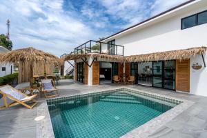 a villa with a swimming pool and a house at Manao Pool Villa 9 - 5 Mins Walk To The Beach in Ko Lanta