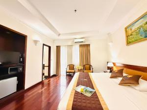 a hotel room with a bed and a television at Huong Sen Hotel in Ho Chi Minh City
