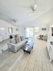 a living room with a couch and a table at Swan Cottages #5 Waterfront in Providenciales