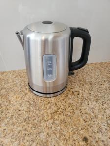 a kettle sitting on top of a counter at Swan Cottages #5 Waterfront in Providenciales +12 photos