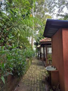 a brick path next to a building with a sink at Orchid Chalet in Ringlet +3 photos
