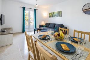a dining room with a table with food on it at Apartamento Atenea in San Bartolomé