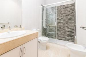 a bathroom with a toilet and a sink and a shower at Apartamento Atenea in San Bartolomé +14 photos