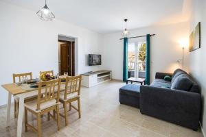 a living room with a couch and a table at Apartamento Atenea in San Bartolomé