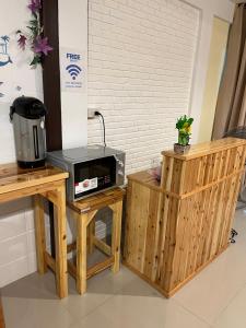 a microwave sitting on a table next to a counter at SDD HoSTEL in Thung Si Kan