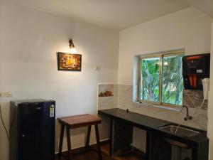 a kitchen with a counter and a sink and a window at Rajdeep by Dacha Arambol in Arambol