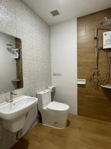 a bathroom with a toilet and a sink at MinimalYala in Yala
