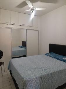 a bedroom with a bed and a room with a unintention at Casa temporada in Lençóis