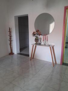 a room with a table with candles and a mirror at Casa temporada in Lençóis