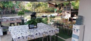 a room with tables and chairs with a view of the water at Open Kitchen Chiang Rai in Chiang Rai