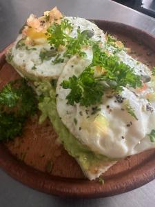 a plate of food with two eggs and broccoli at Eden Heaven Villa in Nuwara Eliya