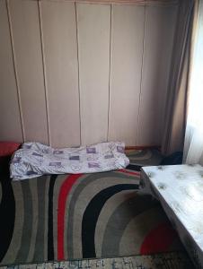 a small room with a bed and a table at Эламан in Otradnoye