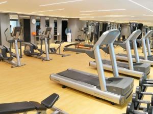 a gym with a lot of tread machines at Novotel Riyadh Al Anoud in Riyadh