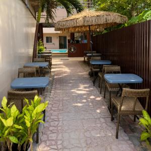 a row of blue tables and chairs and a fence at Iwayan Beach Resort in Panglao Island +4 photos
