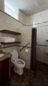 a bathroom with a toilet and a sink at Bungalows Mufrance in San Patricio Melaque +20 photos