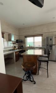 a large kitchen with a large island in the middle at Bungalows Mufrance in San Patricio Melaque