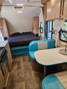 an rv with a bed and a table and chairs at Gold Rush Historical Resort in Sonora