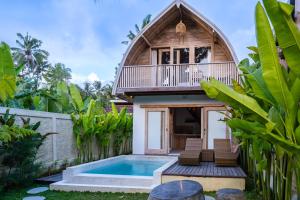 a villa with a pool and a house at Misane Serenity in Gianyar