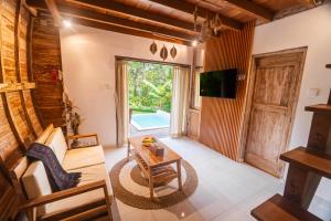 a living room with a couch and a table at Misane Serenity in Gianyar