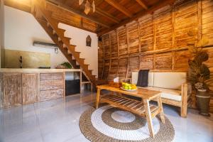 a kitchen with wooden walls and a wooden table at Misane Serenity in Gianyar