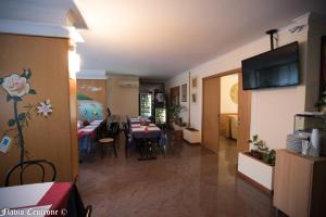 a living room with a table and a dining room at Hotel Cristal in Bari